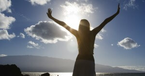 12923-sky-sun-arms-raised-pray-praise-god-beach-ocean-lake-clouds-woman.1200w.tn